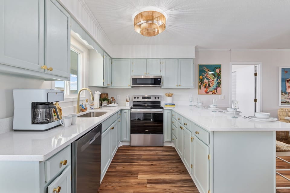 Fully equipped kitchen with all major appliances, including stove, oven, refrigerator, microwave, and dishwasher—perfect for preparing meals, snacks, and enjoying a home-cooked dining experience.