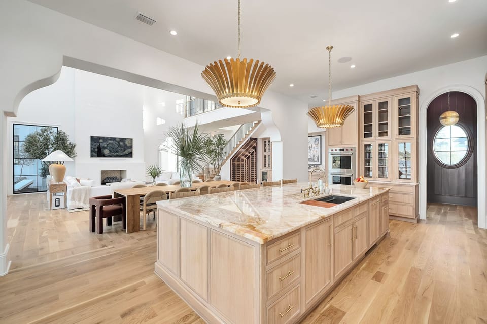 Your dream kitchen awaits with marble countertops, modern appliances, and warm wood tones creating the perfect space for cooking and gathering.