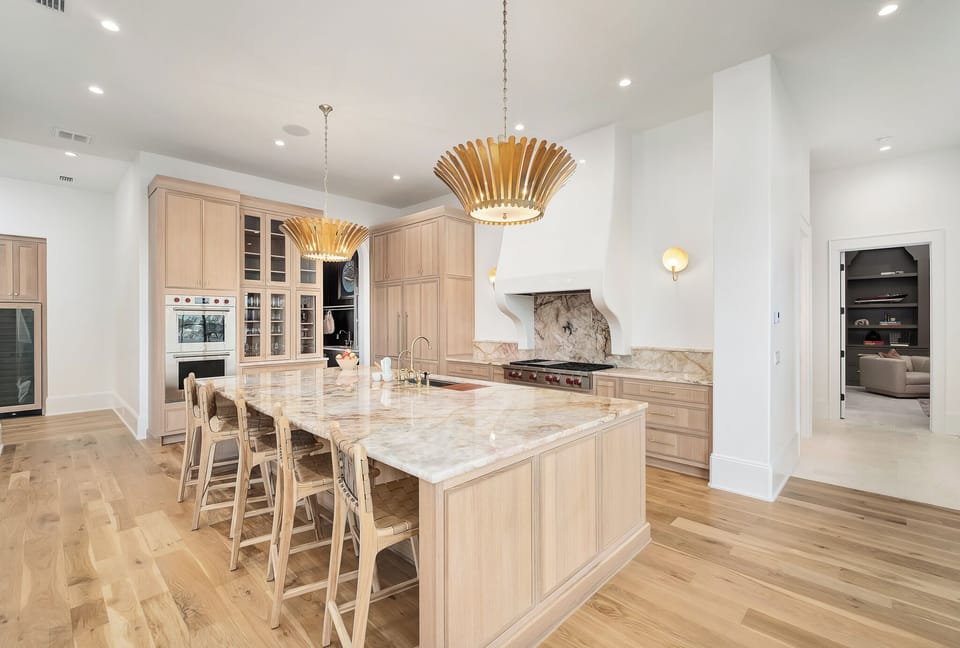 Your gourmet kitchen awaits with stunning marble countertops, custom wood cabinetry, and professional appliances perfect for culinary adventures.