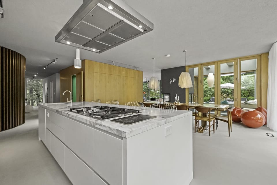Chef-ready kitchen with expansive island and sunlit dining area