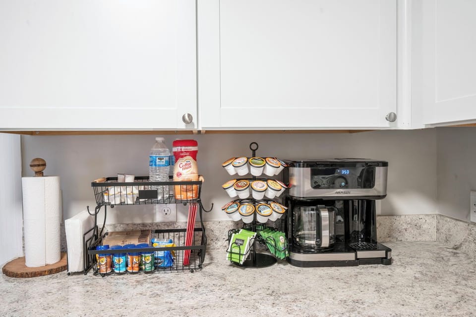 Fully stocked coffee station with roomy counter space and bright kitchen style