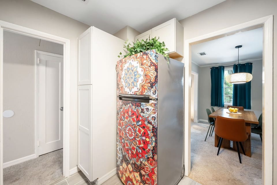 Stylish kitchen nook with colorful fridge and inviting dining room view