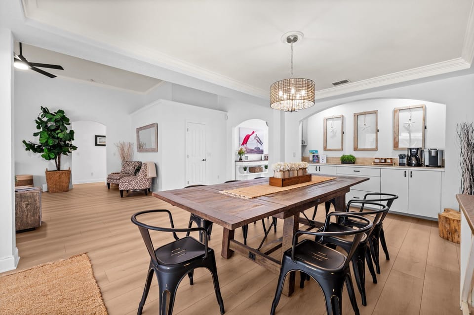 A stylish dining room with a large table perfect for gathering - ideal for shared meals, conversation, and making memories together during your stay.
