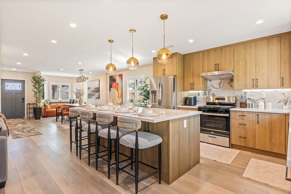 Fully equipped kitchen with oven, range, refrigerator, cooking utensils. 
