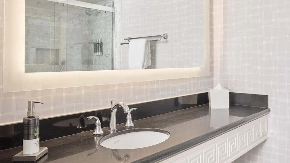 Refresh each morning with a sleek vanity and bright mirror.
