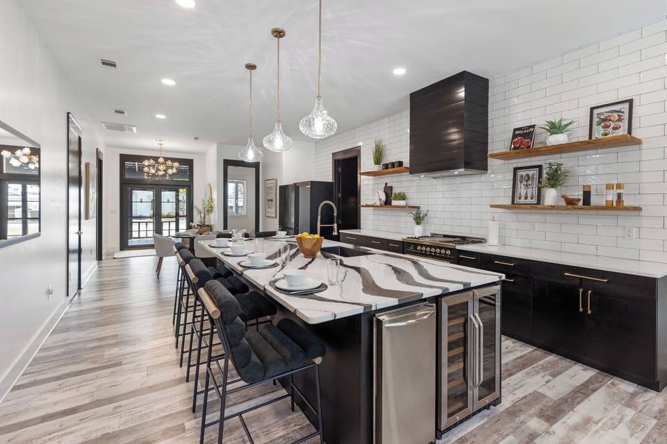 Your gourmet kitchen features marble countertops, modern appliances, and stylish pendant lighting perfect for cooking memorable meals together.