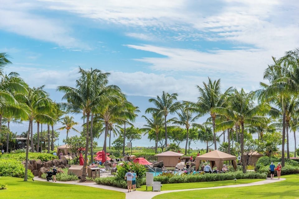 Tropical paradise retreat with palm trees, cabanas, and ocean breeze. HKK-225