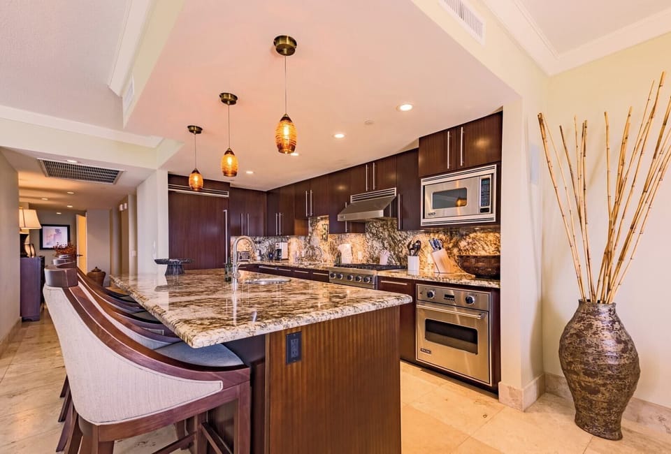 Stylish kitchen with granite counters and pendant lighting, designed for both chefs and casual grazers. HKK-450