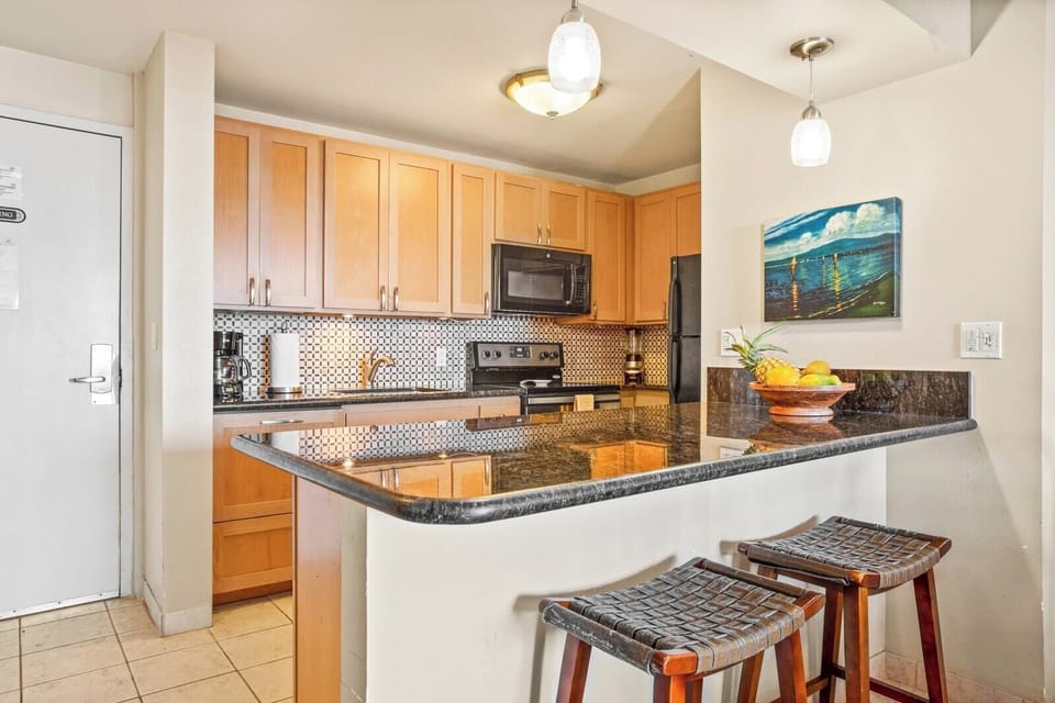 Whip up meals or sip coffee at the breakfast bar in this warm, well-appointed kitchen with island flair and comfort     VIR-508
