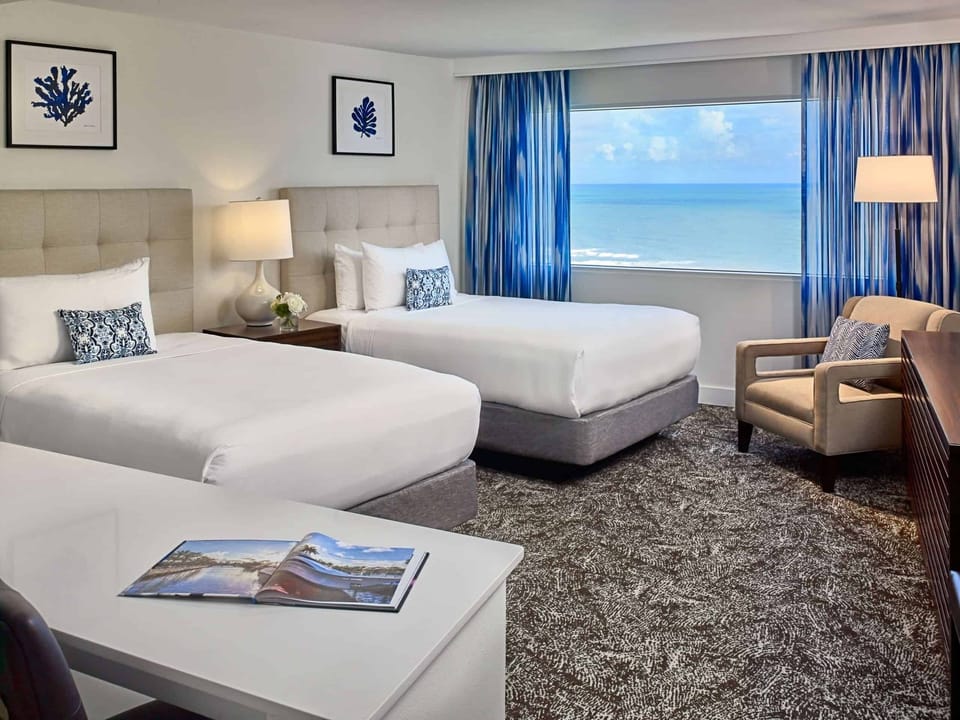 Lounge comfortably in a bright room with ocean scenery.