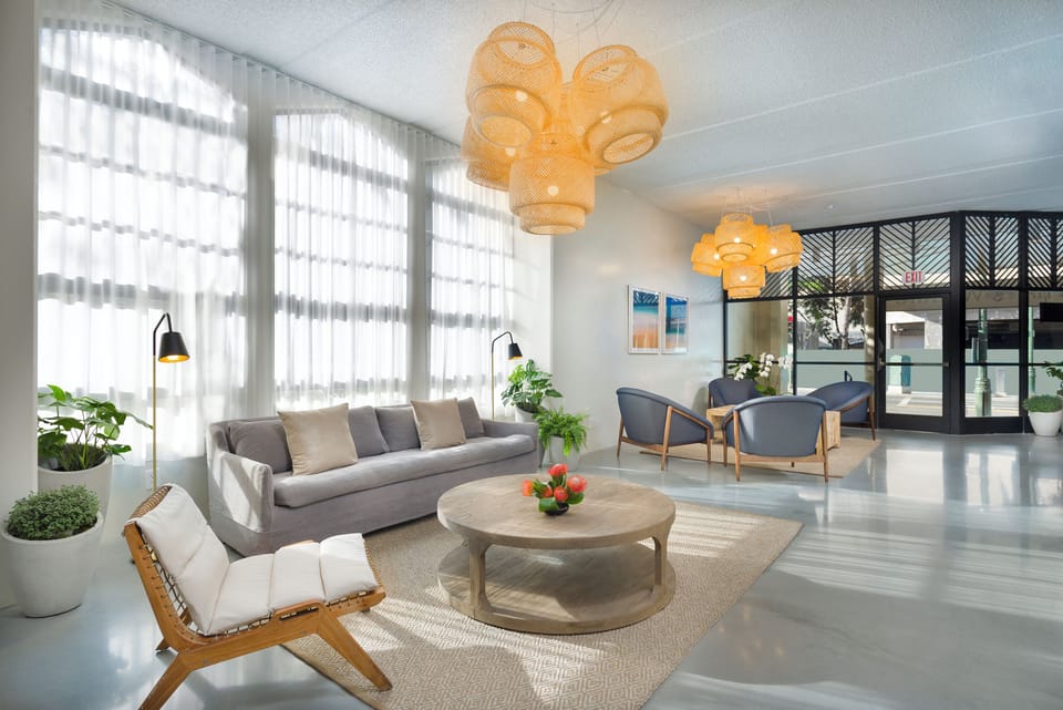 Unwind in a light-filled lobby with breezy resort vibes.