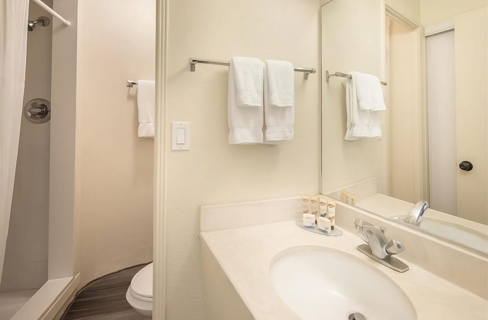 Freshen up in a spotless bathroom with mirrored vanity space.