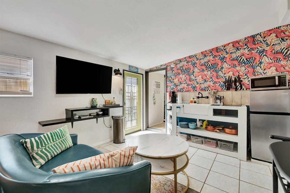 Open studio with sofa, TV, and bed