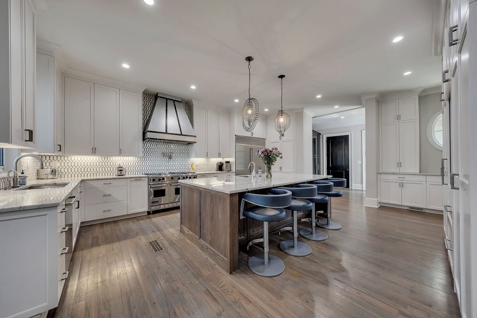 Modern kitchen w/ island seating & pendant lighting, ideal for cooking & conversation