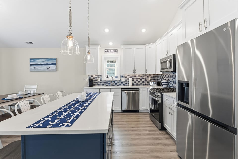Bright coastal kitchen with large island and sleek stainless appliances