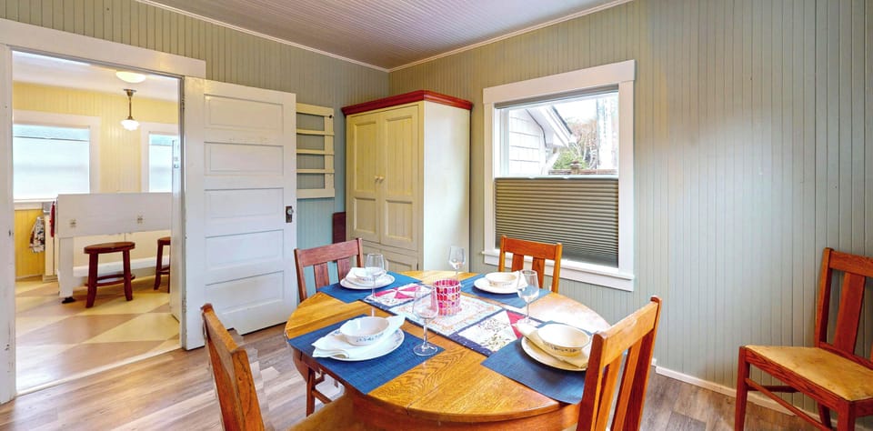 Gather around this charming dining table where your meals become memorable moments in this cozy cottage-style space.