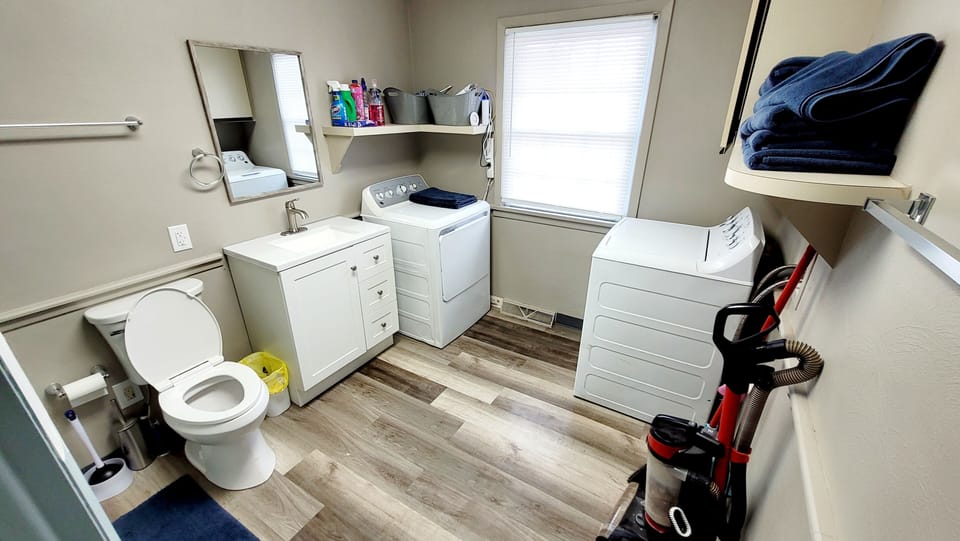 Full bathroom with shower, washer, dryer.