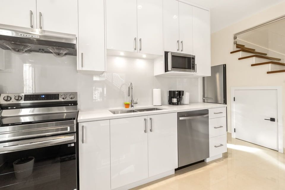Kitchen with coffee machine, kettle, and basic cooking essentials.