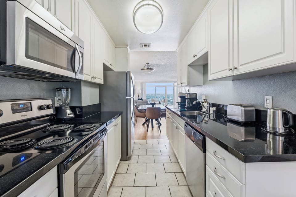 Bright, contemporary kitchen featuring premium appliances and ample prep space.