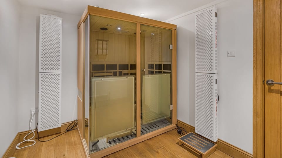 The three-person infra-red sauna with red light therapy panels offers full-body relaxation and healing.