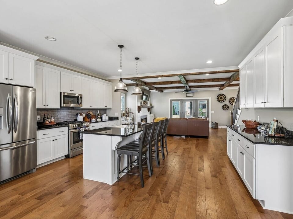 Kitchen area with island and bar stools