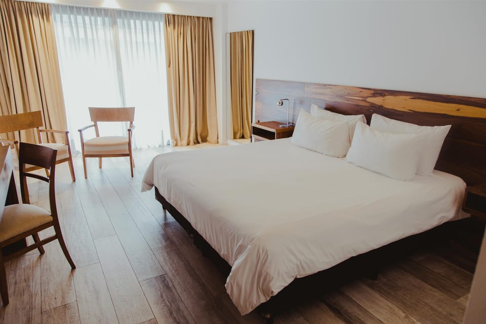 Unwind in a sunlit bedroom with crisp linens.