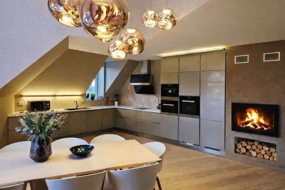 The spacious livingroom, kitchen, and dining area has a cozy woodburner.