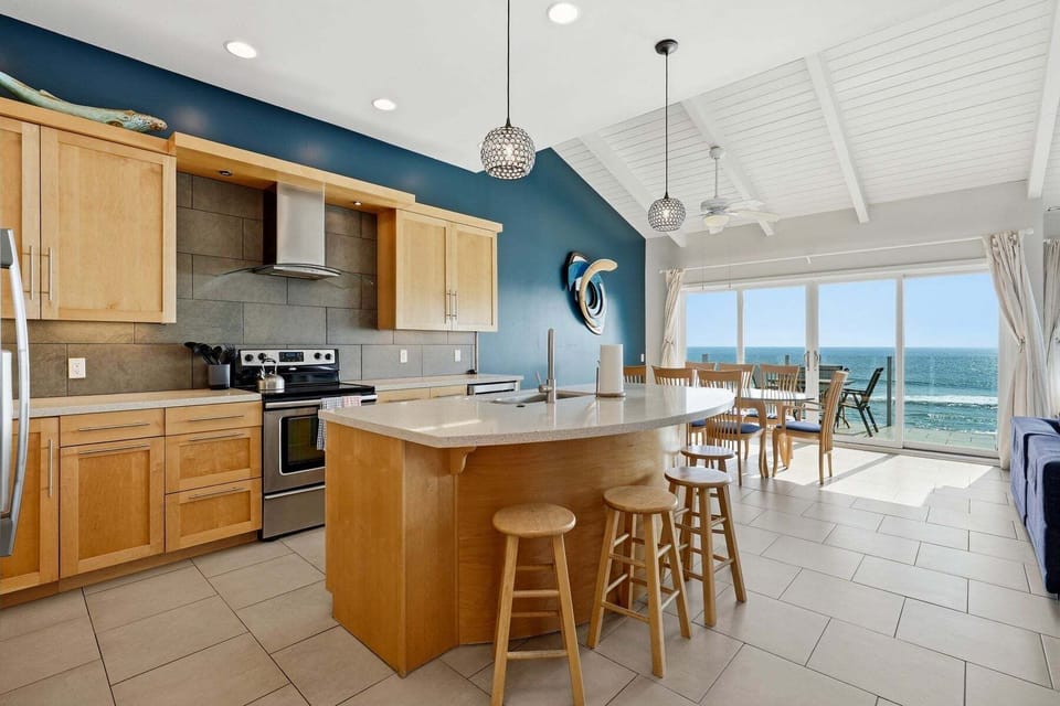 Open kitchen and dining with panoramic ocean views
