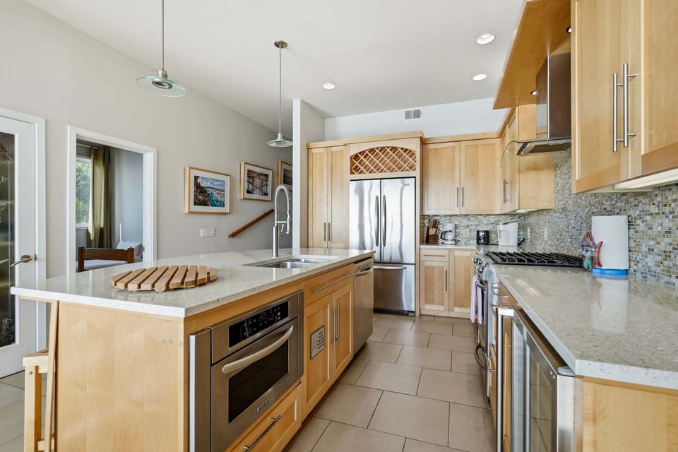 Fully equipped kitchen with stainless steel appliances and ample counter space