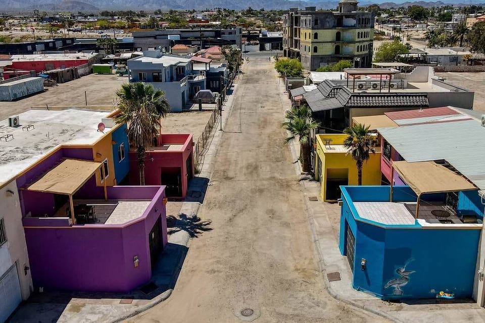 This street-level view shows the condo's location at the end of a quiet private road, just steps from the beach and a short walk to the Malecon's restaurants and shops