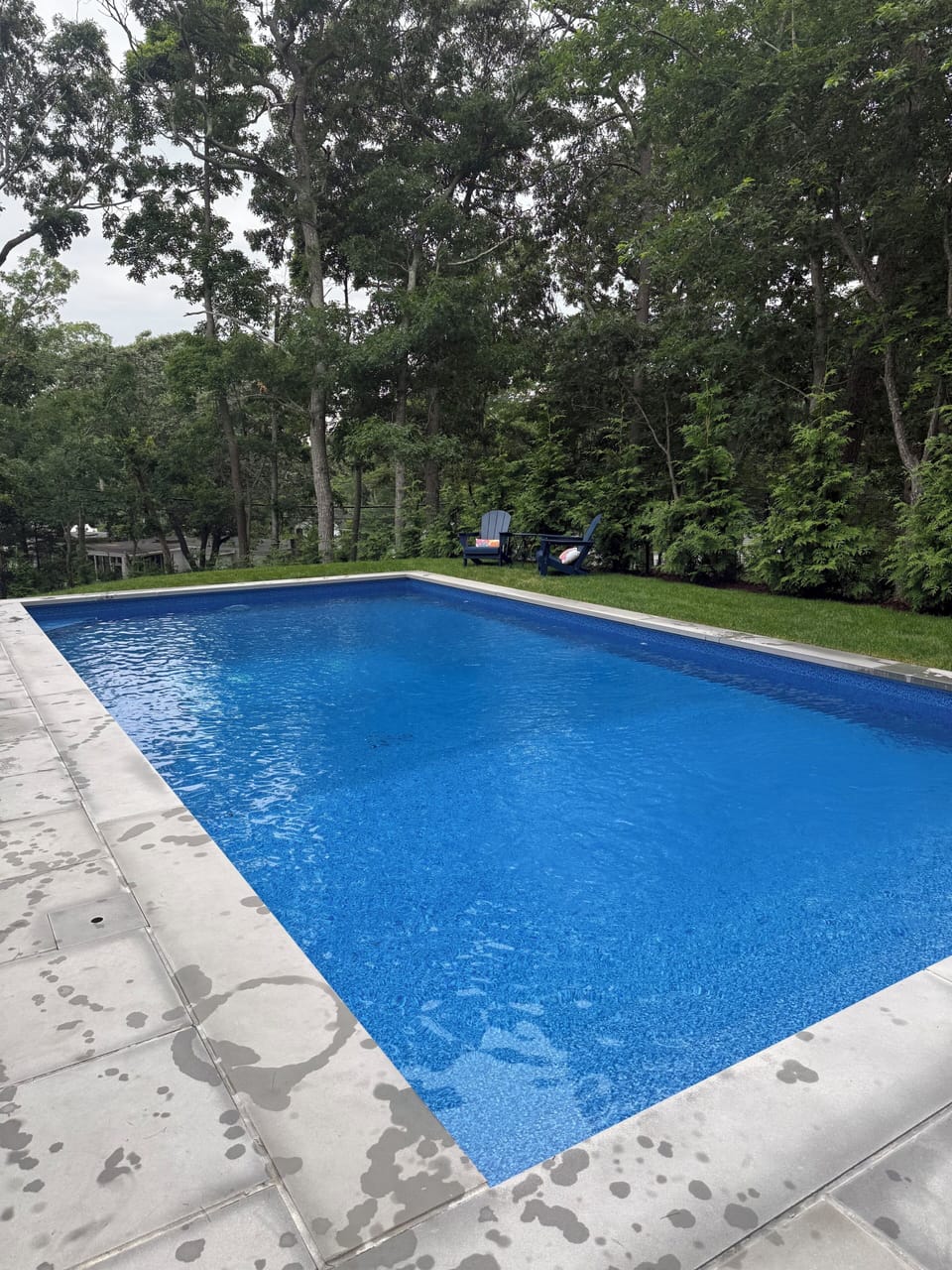 Private salt water pool with sun chairs and dining table 
