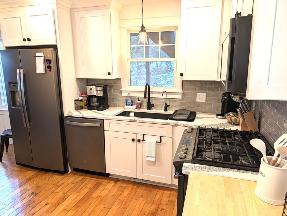 KITCHEN (MAIN FLOOR):  Fully-functional modern kitchen with newer appliances including a dishwasher and a gas range.
