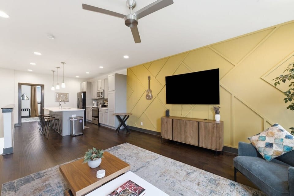 Unwind in the expansive living room, featuring a seamless open floor plan that flows into the kitchen/dining area. Engage in lively games or conversation in this comfortable living area with plenty of seating.