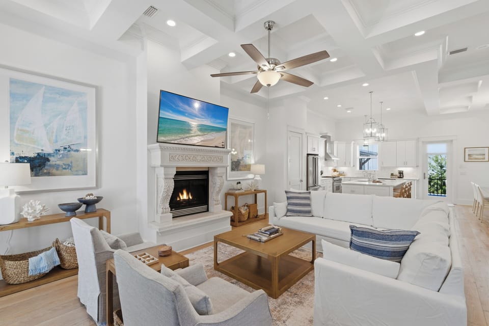 Unwind in your elegant living room where coffered ceilings and a crackling fireplace create the perfect atmosphere for relaxation.