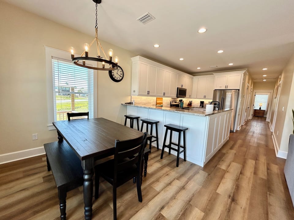 Dining table seats 6-8. 3 additional seats at the breakfast bar.
