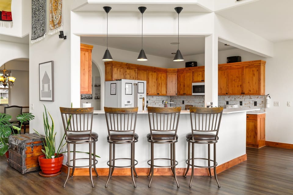 Bright open kitchen with breakfast bar seating for four