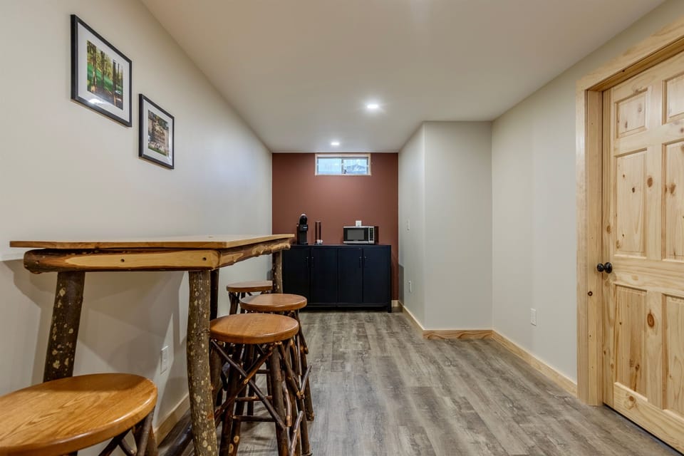 Basement living area with space to hang out, king bedroom, bathroom, electric fireplace, microwave, K-cup coffee maker and smart TV.