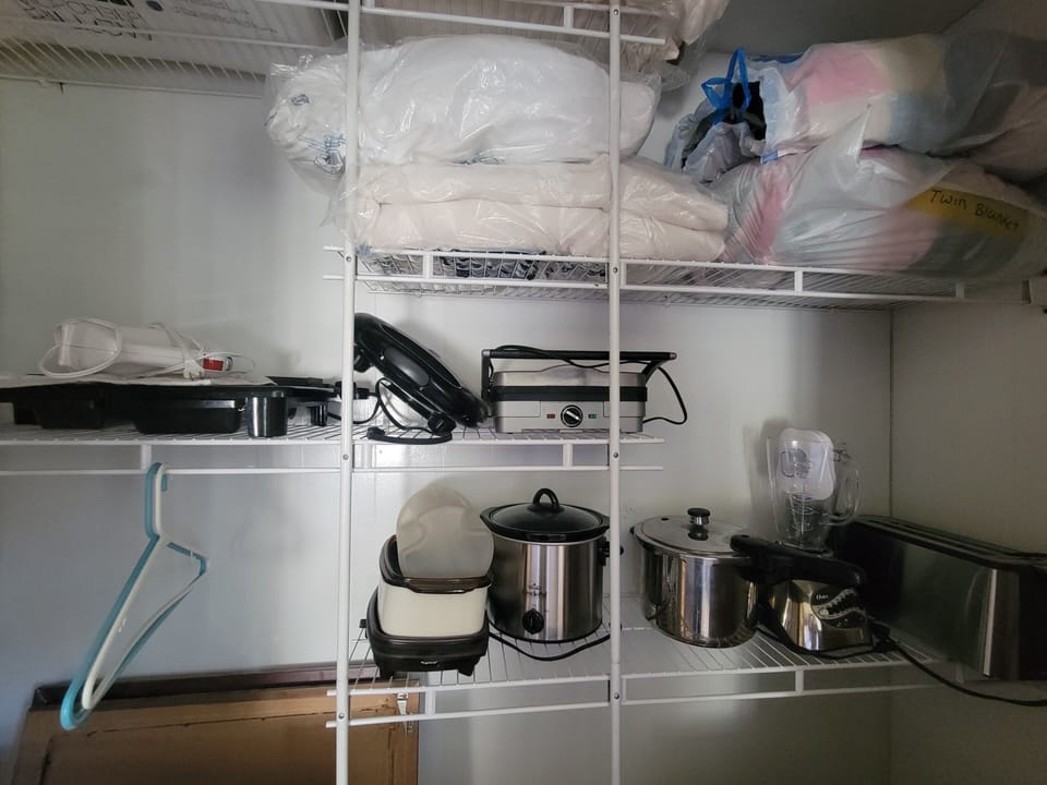 Extra kitchen appliances in closet of bedroom