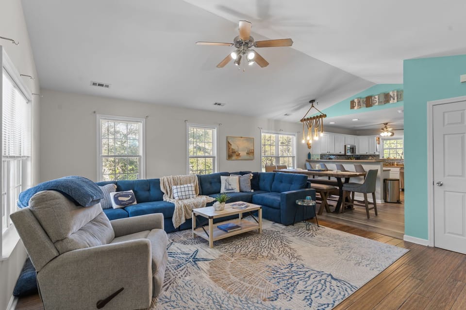 "Coastal‑style living area with smart TV and comfortable seating"