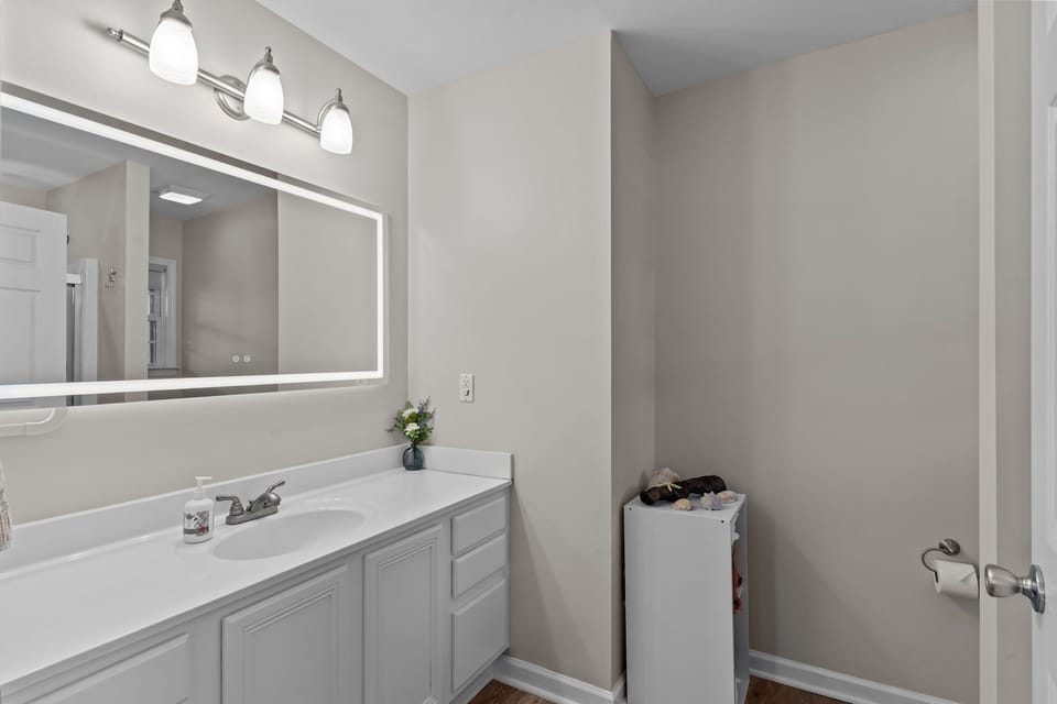 “Clean modern bathroom in renovated Oak Island beach house”