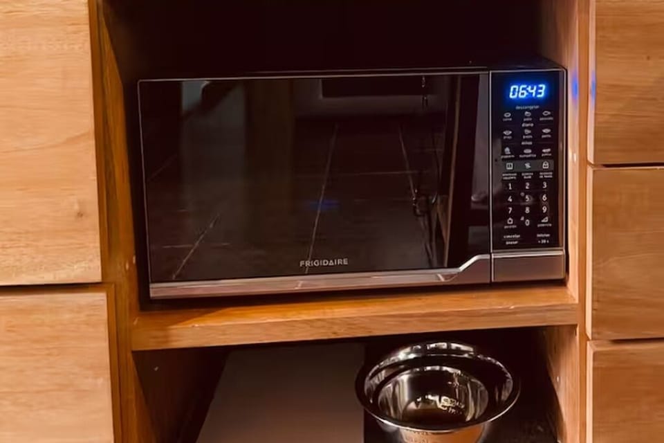 Microwave, mixing bowls and cutting board