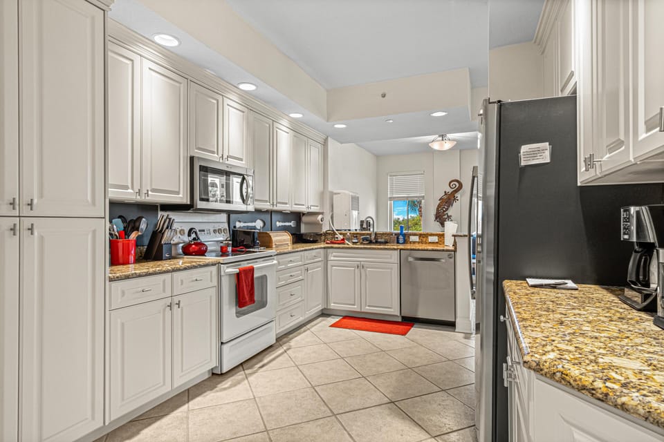 Bright, spacious kitchen with modern appliances and granite countertops