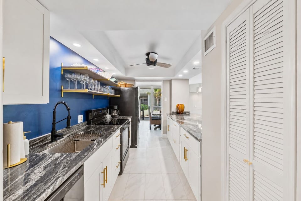 Fully stocked kitchen with cookware, plates, utensils, and all your dining essentials — plus a refrigerator with built-in ice maker and water filter.
