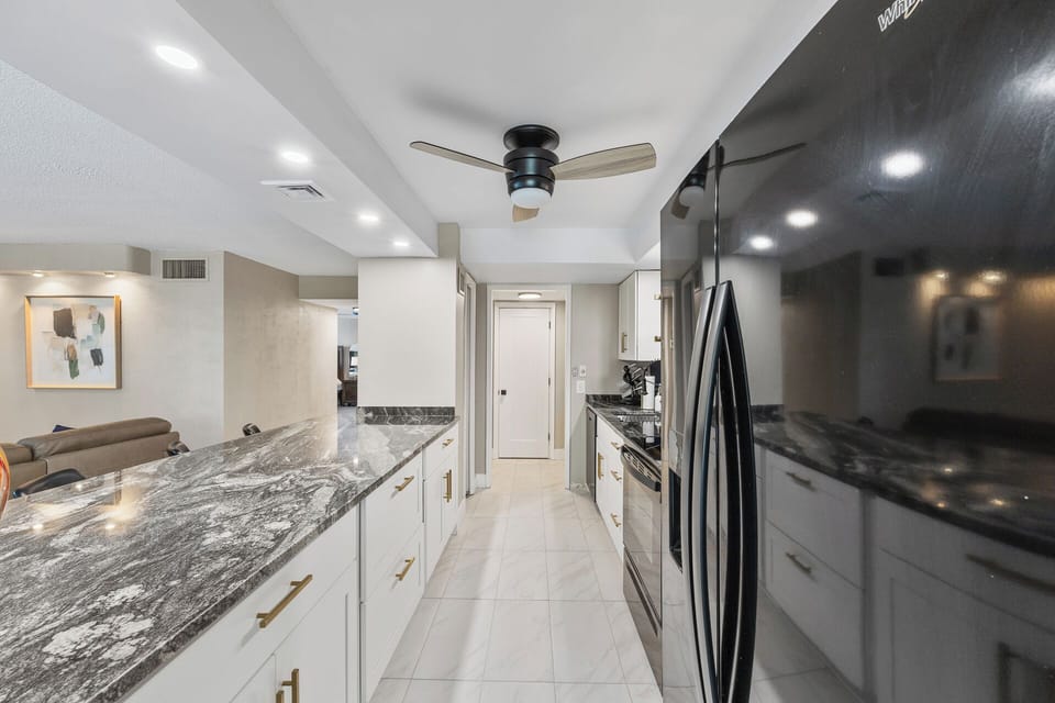 Fully stocked kitchen with cookware, plates, utensils, and all your dining essentials — plus a refrigerator with built-in ice maker and water filter.