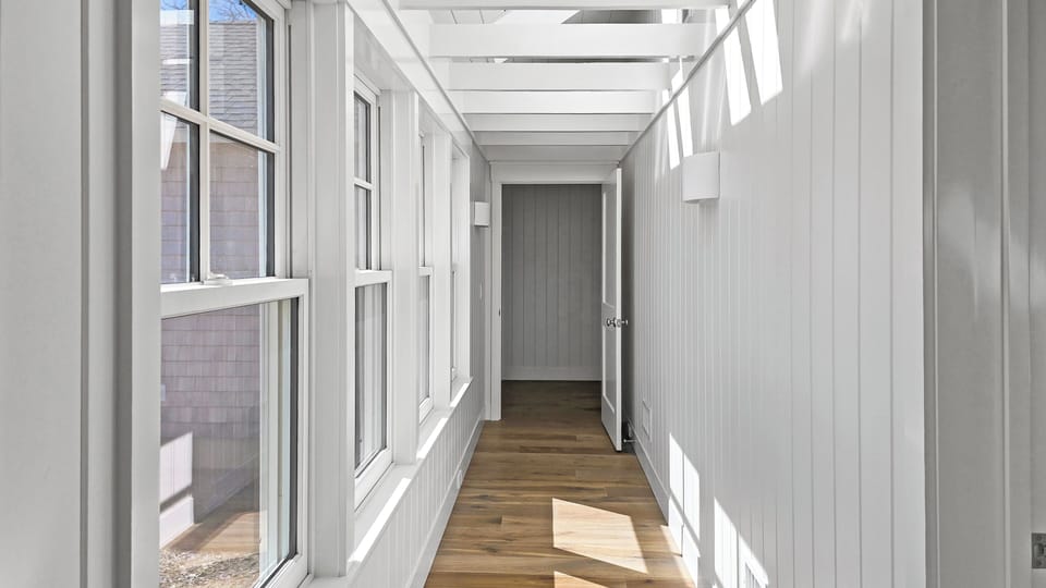 Bright hallway leading to bedrooms in the main house