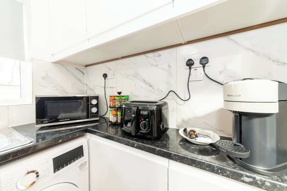 Kitchen from a wider angle showing the full worktop and storage. Pots, pans, plates, cutlery. It is all here. Cook real food, save real money.