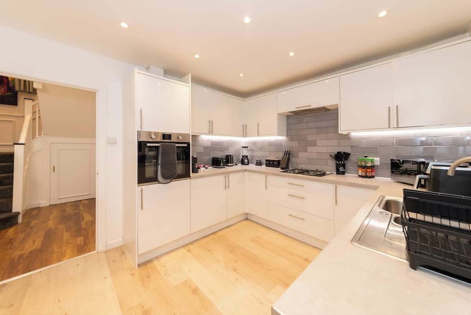 Full kitchen with oven, hob, dishwasher, microwave, and proper crockery. Cook real meals to save per diem or prep a family feast. Dining seats 8, plus bar stools for casual breakfasts.