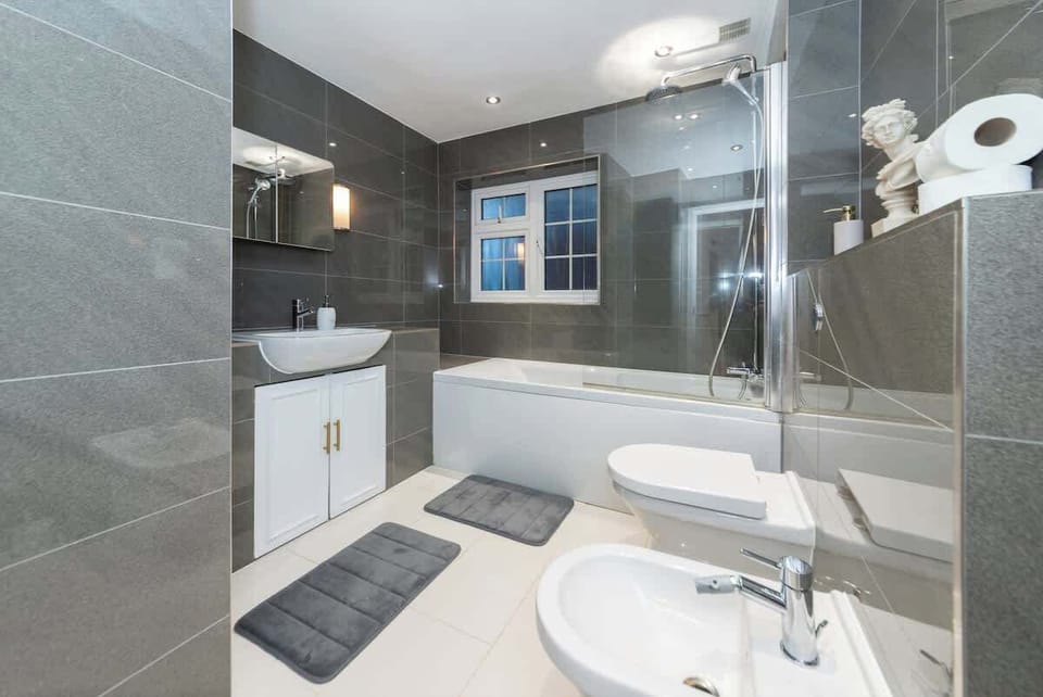 Modern bathroom with powerful shower, full-size bath, and heated towels. Consistent hot water, no waiting, no trickle. Space for morning queues whether it's shift workers or the whole family.