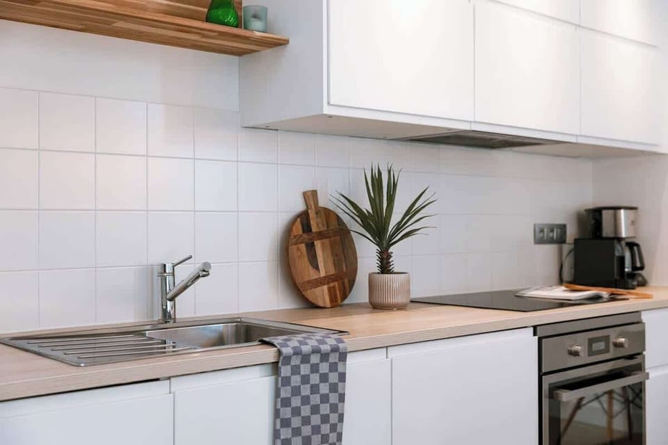 Contemporary kitchen with wooden shelves and a natural flow.
