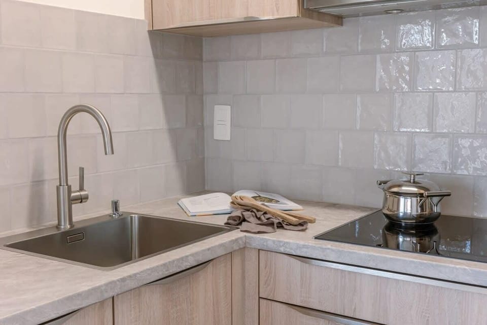 Modern kitchen corner with stainless steel sink and induction cooktop